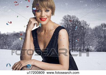 Woman in party dress sitting in snow View Large Photo Image Stock Photo - Woman in party dress sitting in snow. Fotosearch