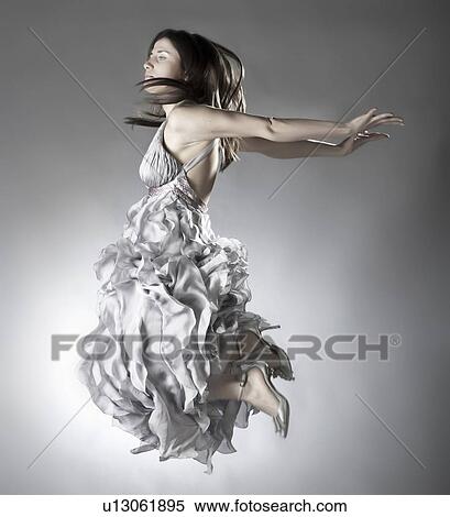 Woman jumping in ornate dress View Large Photo Image Stock Photography - Woman jumping in ornate dress. Fotosearch