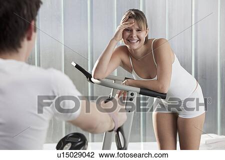 Woman laughing on exercise machine View Large Photo Image Stock Image - Woman laughing on exercise machine. Fotosearch