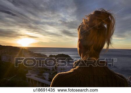 Woman overlooking coastal town View Large Photo Image Stock Photography - Woman overlooking coastal town. Fotosearch