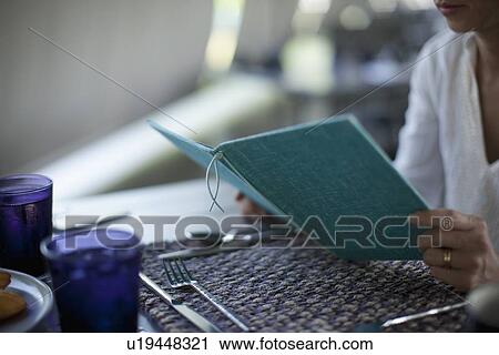 Woman reading at breakfast table View Large Photo Image Stock Image - Woman reading at breakfast table. Fotosearch
