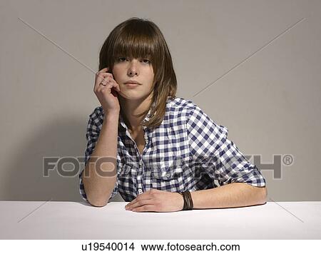 Picture - Woman sitting at desk. Fotosearch