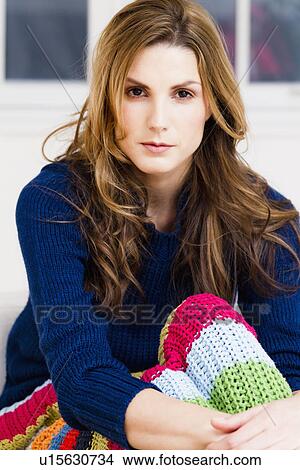 Woman sitting under throw blanket View Large Photo Image Picture - Woman sitting under throw blanket. Fotosearch