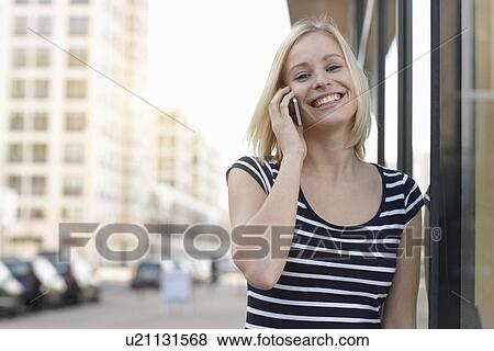 Woman talking on cell phone outdoors View Large Photo Image Stock Photo - Woman talking on cell phone outdoors. Fotosearch