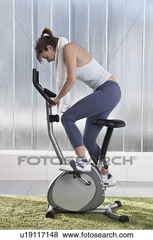 Woman using exercise machine View Large Photo Image Stock Photo - Woman using exercise machine. Fotosearch