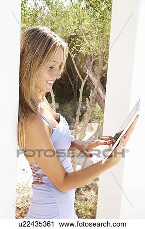 Woman using tablet computer outdoors View Large Photo Image Stock Image - Woman using tablet computer outdoors. Fotosearch