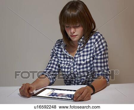 Woman using tablet computer View Large Photo Image Stock Photo - Woman using tablet computer. Fotosearch