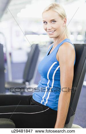 Woman using weights machine in gym View Large Photo Image Stock Photo - Woman using weights machine in gym. Fotosearch