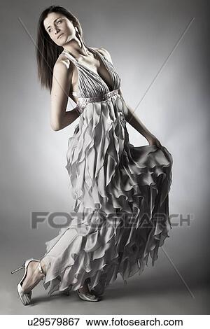 Stock Photo - Woman wearing ornate gown. Fotosearch