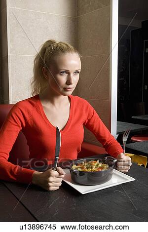 Stock Photography - Woman with plate of food in cafe. Fotosearch