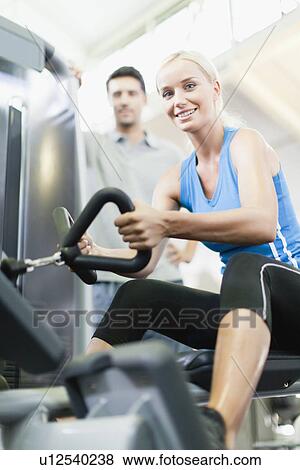 Woman working with trainer in gym View Large Photo Image Stock Photo - Woman working with trainer in gym. Fotosearch