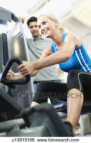 Woman working with trainer in gym View Large Photo Image Stock Photograph - Woman working with trainer in gym. Fotosearch