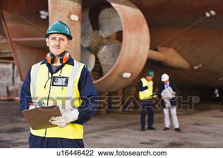 Worker carrying clipboard on dry dock View Large Photo Image Stock Image - Worker carrying clipboard on dry dock. Fotosearch