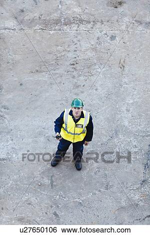 Worker standing on dry dock View Large Photo Image Stock Photograph - Worker standing on dry dock. Fotosearch