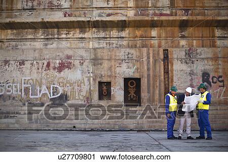 Workers reading blueprints on dry dock View Large Photo Image Stock Image - Workers reading blueprints on dry dock. Fotosearch