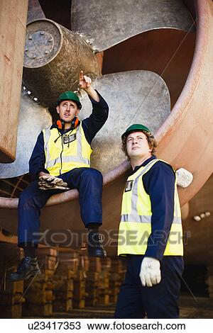 Workers talking in propeller on dry dock View Large Photo Image Stock Image - Workers talking in propeller on dry dock. Fotosearch