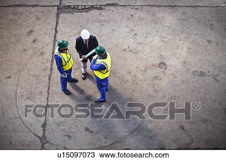 Workers with blueprints on dry dock View Large Photo Image Stock Image - Workers with blueprints on dry dock. Fotosearch