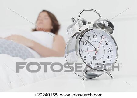 Alarm clock on bedside table View Large Photo Image Stock Photography - Alarm clock on bedside table. Fotosearch