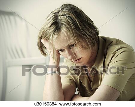 Anxious woman resting head in hand View Large Photo Image Picture - Anxious woman resting head in hand. Fotosearch
