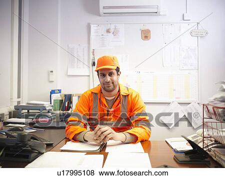 Stock Photo - Apprentice engineer at office desk. Fotosearch