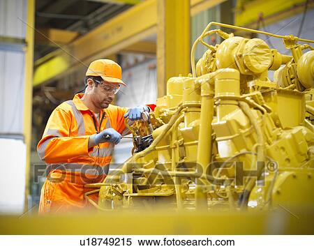 Apprentice engineer at work in factory View Large Photo Image Stock Photography - Apprentice engineer at work in factory. Fotosearch