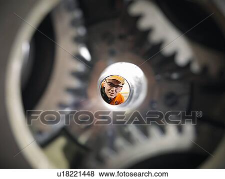 Apprentice engineer examining gears View Large Photo Image Stock Photo - Apprentice engineer examining gears. Fotosearch