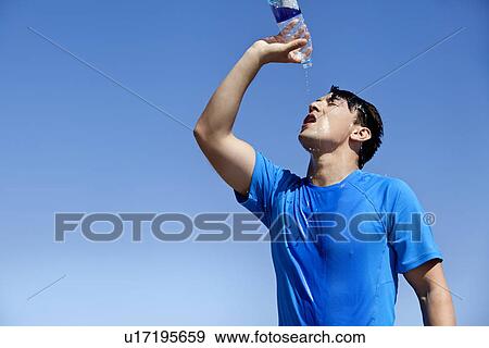 Athlete cooling off with water outdoors View Large Photo Image Stock Photo - Athlete cooling off with water outdoors. Fotosearch