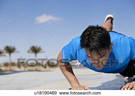 Athlete doing push-ups outdoors View Large Photo Image Stock Photo - Athlete doing push-ups outdoors. Fotosearch