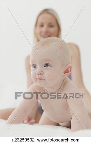 Baby crawling on bed View Large Photo Image Stock Image - Baby crawling on bed. Fotosearch