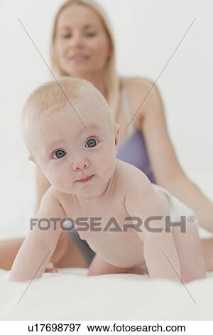 Baby crawling on bed View Large Photo Image Stock Photo - Baby crawling on bed. Fotosearch