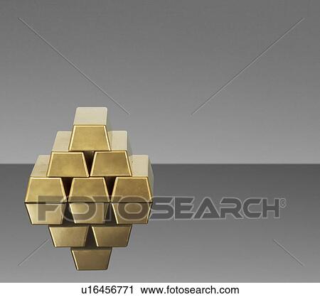 Stock Image - Bars of gold reflected in countertop. Fotosearch