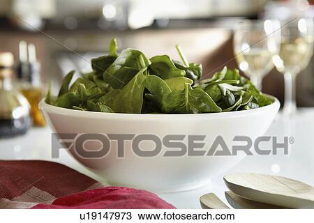 Bowl of spinach salad on kitchen table View Large Photo Image Stock Image - Bowl of spinach salad on kitchen table. Fotosearch