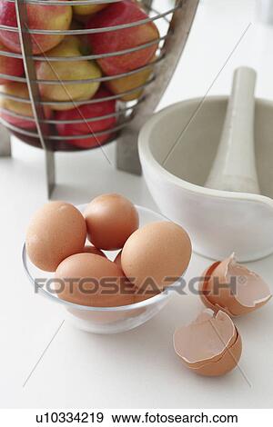 Stock Photo - Bowls of eggs and apples. Fotosearch