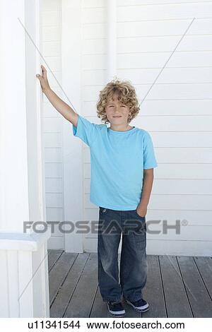 Boy leaning on pillar outdoors View Large Photo Image Picture - Boy leaning on pillar outdoors. Fotosearch