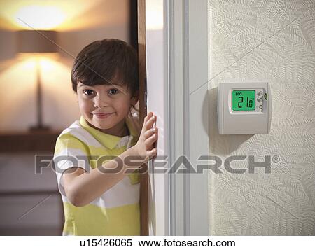 Stock Photography - Boy peeking around doorway. Fotosearch