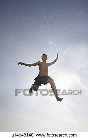 Boy posing in mid-air View Large Photo Image Stock Photo - Boy posing in mid-air. Fotosearch