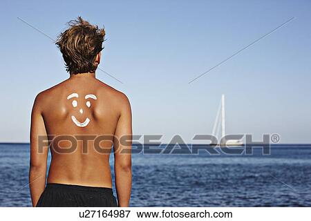 Boy with drawing in sunscreen on back View Large Photo Image Stock Photo - Boy with drawing in sunscreen on back. Fotosearch