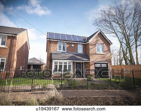 Stock Photo - Brick house behind iron gate. Fotosearch