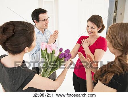 Business people giving colleague flowers View Large Photo Image Stock Image - Business people giving colleague flowers. Fotosearch
