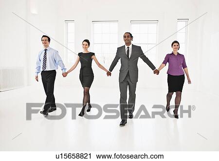 Business people holding hands in office View Large Photo Image Stock Image - Business people holding hands in office. Fotosearch