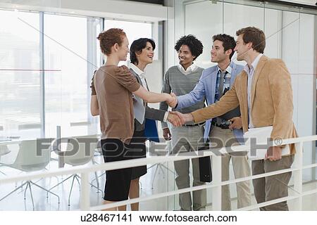 Business people shaking hands in office View Large Photo Image Stock Image - Business people shaking hands in office. Fotosearch