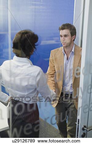 Stock Photo - Business people shaking hands in office. Fotosearch