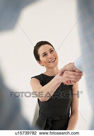 Stock Image - Business people shaking hands. Fotosearch