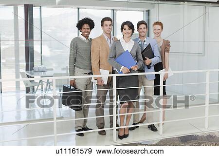 Stock Photo - Business people smiling in office. Fotosearch