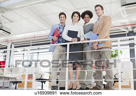 Stock Image - Business people smiling together. Fotosearch