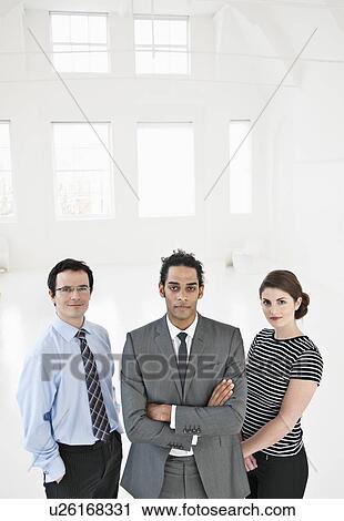 Business people standing in office View Large Photo Image Stock Image - Business people standing in office. Fotosearch