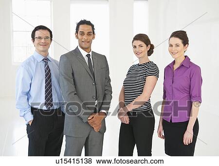 Business people standing in office View Large Photo Image Stock Photo - Business people standing in office. Fotosearch