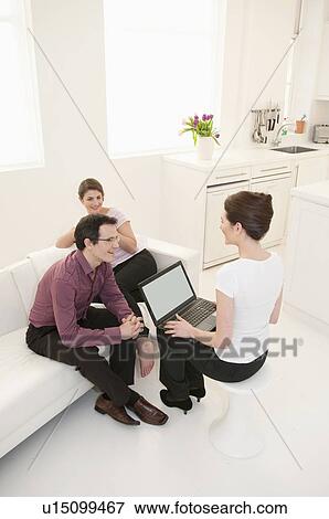 Stock Photo - Business people talking in break room. Fotosearch