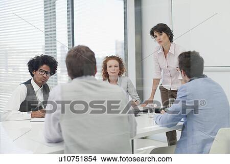 Picture - Business people talking in meeting. Fotosearch