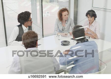 Stock Image - Business people talking in meeting. Fotosearch